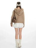 Back view of woman in beige faux fur hooded cardigan jacket