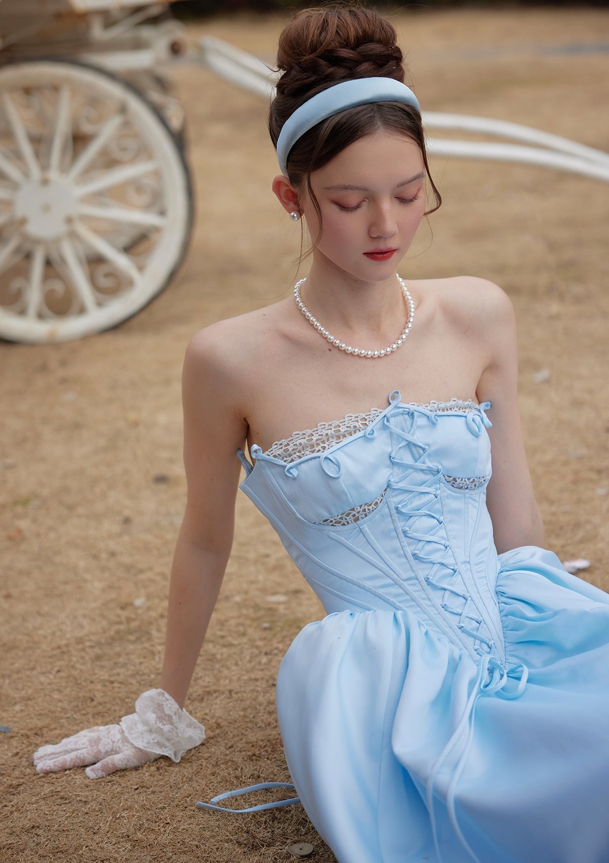 Full shot of a light blue strapless gown displayed on a mannequin against a white background.