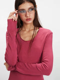 Detail of the neckline on a rose red long sleeve top