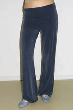Close-up of navy velour wide leg pants with a flared hem and a high rise elastic waistband.