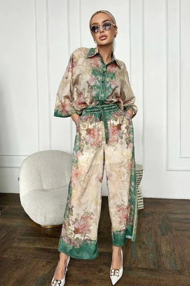 Woman wearing a floral print matching set featuring a button-down shirt and wide-leg pants.