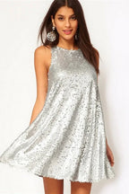 Woman wearing a silver sequined sleeveless A-line mini dress, front view