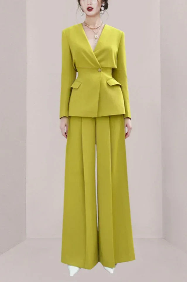 Woman wearing a lime green tailored suit with wide-leg pants and a V-neck blazer.