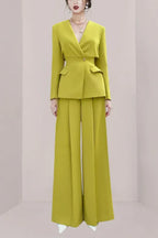 Woman wearing a lime green tailored suit with wide-leg pants and a V-neck blazer.
