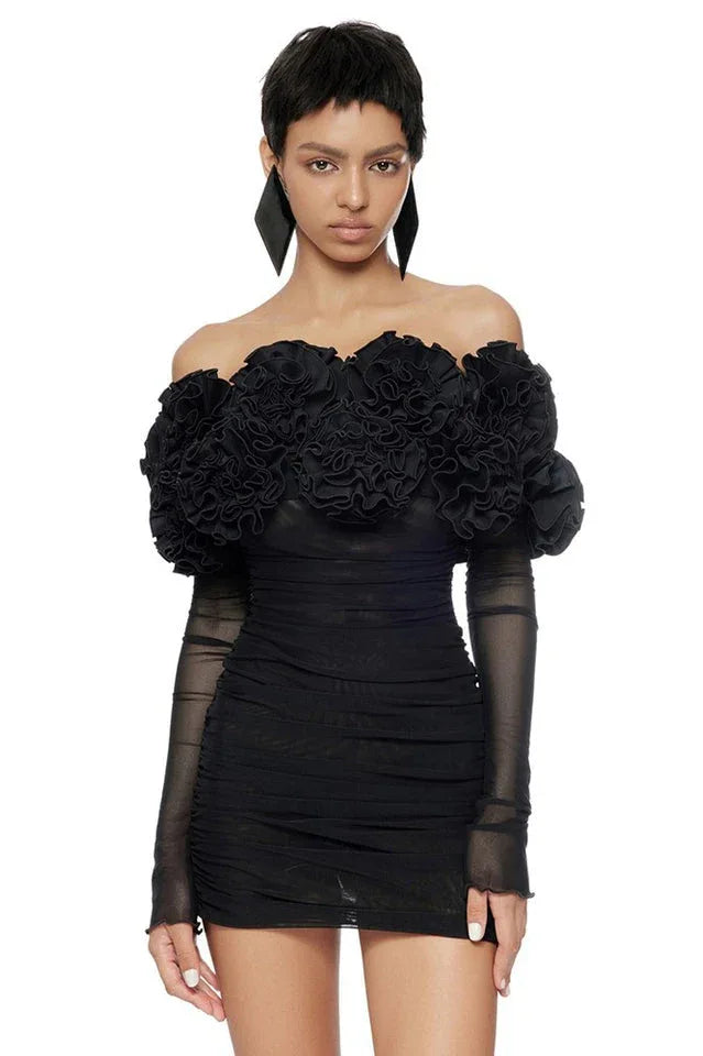 Model showcasing a black off-the-shoulder ruffled mini dress with mesh sleeves