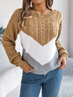 Front detail of a woman in a tan, white, and grey chevron color block knit sweater