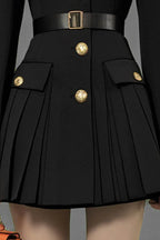 close-up of pleated skirt and pockets on black dress
