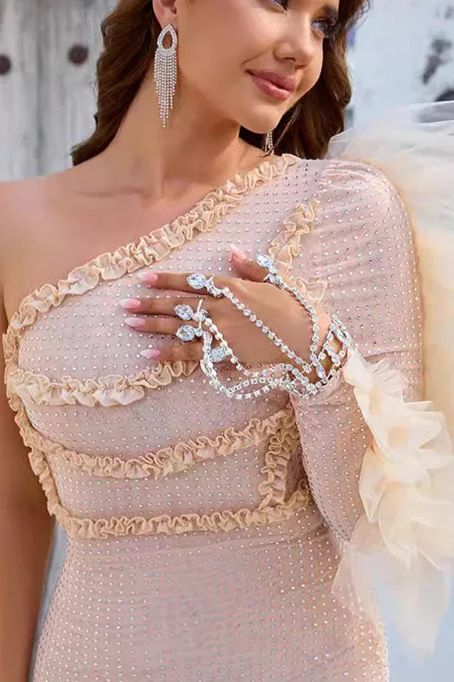 Detail of the embellishments and ruffled neckline on a women's party dress.