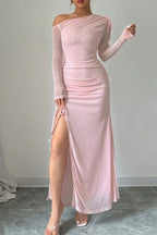 Close-up of a woman's legs and the side slit of a pink ruched maxi dress.