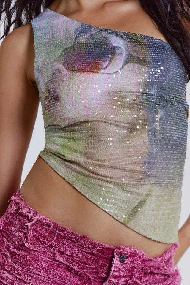 Close-up of the sequined one-shoulder top with a graphic print.