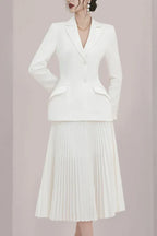 Side profile of a woman in a white formal suit set.