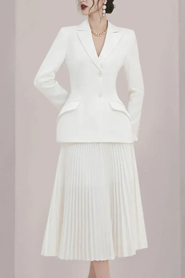 Side profile of a woman in a white formal suit set.