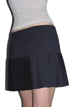 Side view of a black pleated mini skirt with a high waist and A-line silhouette.