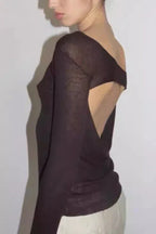 Side view of a dark brown sheer long-sleeve top with an asymmetrical neckline and an open back detail.