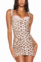 Woman wearing a leopard print bodycon mini dress with pink lace trim and a scoop neckline.