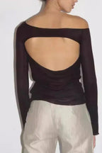 Back view of a dark brown sheer long-sleeve top with a large open back cutout.