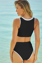 Rear view of a woman in a black bikini with white trim