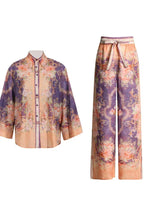 Purple and orange floral print matching set including a button-down shirt and wide-leg pants.