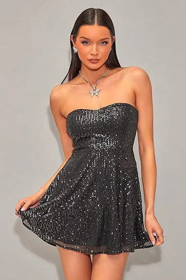 Woman wearing a black strapless sequin mini dress with a sweetheart neckline and flared skirt.
