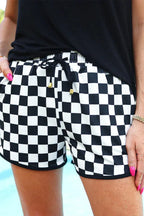 Close-up of black and white checkered athletic shorts with drawstring and pockets