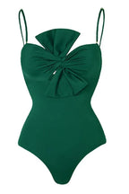 Detail of a green one-piece swimsuit with a bow detail on the bust and thin straps.