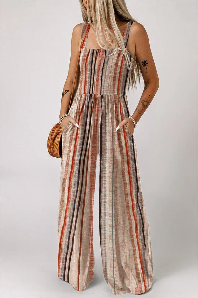 Woman wearing a striped wide-leg jumpsuit with smocked bodice and square neckline