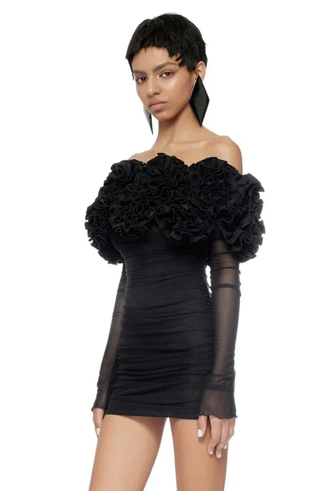 Front view of a black ruffled off-the-shoulder dress with long sheer sleeves