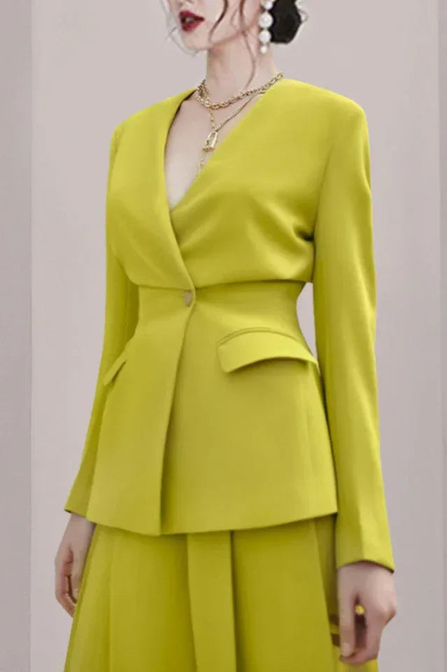 Close-up of the lime green V-neck blazer with a double-breasted closure and flap pockets.