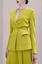 Close-up of the lime green V-neck blazer with a double-breasted closure and flap pockets.