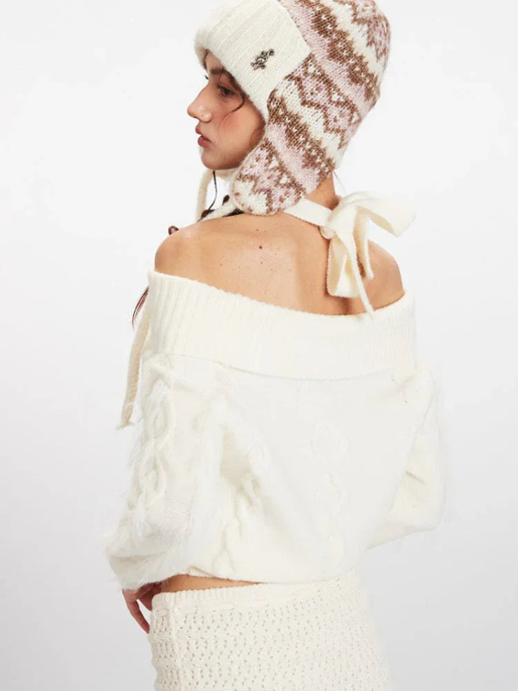 Back view of a white off-the-shoulder cable knit sweater with tie detail