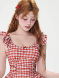 Close-up of the neckline and bodice of a red and white gingham dress