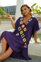 Woman wearing a purple kaftan with crocheted paneling, seated outdoors