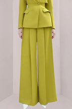 Close-up of the lime green wide-leg pleated pants.