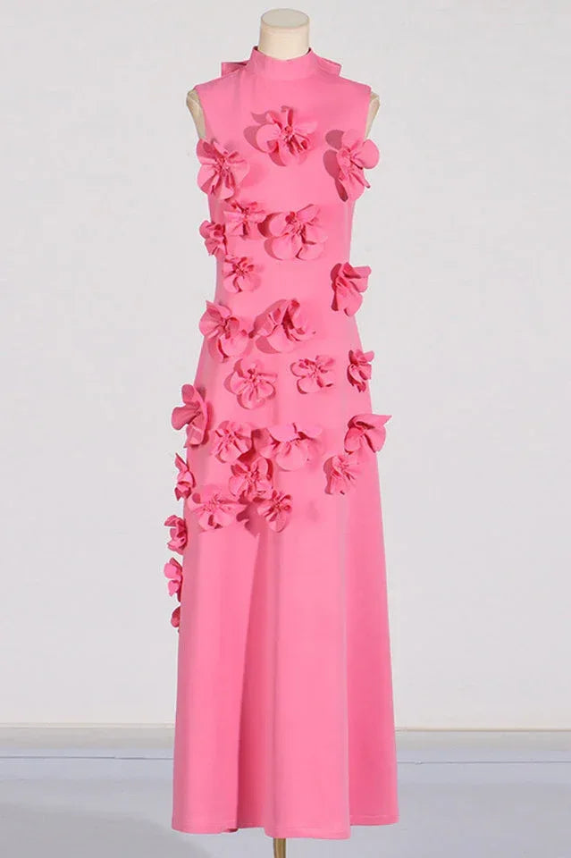 Full-length view of a pink sleeveless dress adorned with floral appliqués.