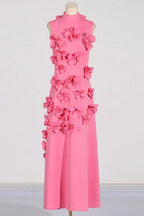 Full-length view of a pink sleeveless dress adorned with floral appliqués.