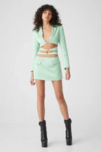Side view of a mint green cut out blazer dress
