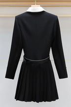 back view of black dress with pleated skirt and belt