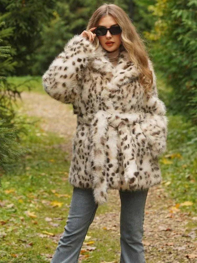 Woman wearing a spotted faux fur coat cinched with a belt
