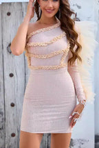 Close-up of a woman in a shimmering one-shoulder dress with intricate ruffled trim.