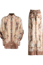 Brown and pink floral print matching set consisting of a button-down shirt and wide-leg pants.