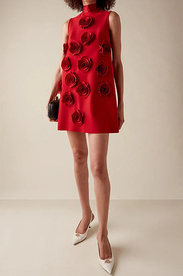 Red sleeveless A-line dress with 3D rose embellishments and a high neckline, worn by a model with a black clutch.