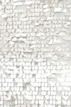 Close-up of silver sequins on a mesh fabric