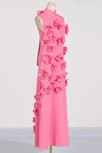 Side profile of a pink sleeveless maxi dress with floral embellishments and a mock neck, on a mannequin.