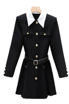 black dress with white collar and gold buttons on a hanger