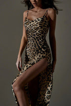 Close-up of a woman's torso in a leopard print satin slip dress with a high slit