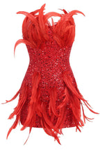 Close-up of a red sequin and feather mini dress