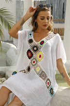 Woman wearing a white kaftan with crocheted detailing, seated outdoors