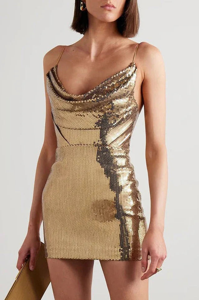 Close-up of a woman wearing a gold sequined mini dress with a cowl neckline.