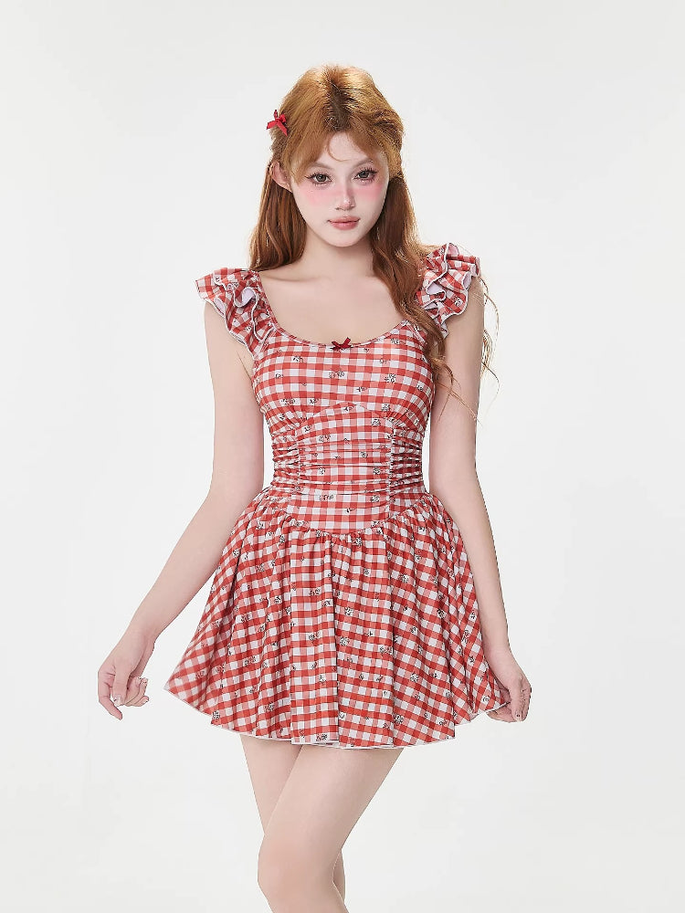 Woman posing in a red and white gingham dress
