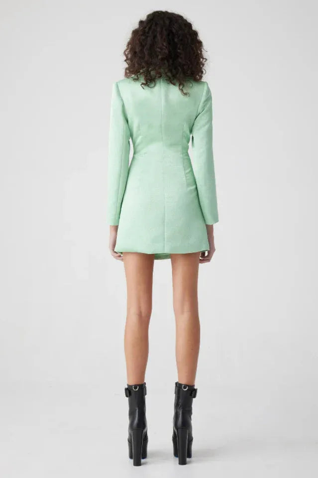 Front view of a woman in a mint green cut out blazer dress with V-neckline